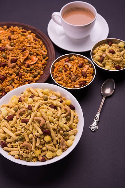 indian famous snack called farsan or chivada or chakna with hot tea